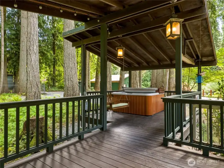 Covered trex deck with room for BBQ and a cozy hot tub make this a true vacation home vibe!