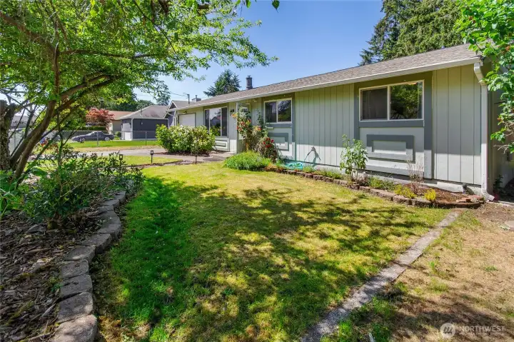 Side view of updated front yard with nice landscaping and RV boat parking on side