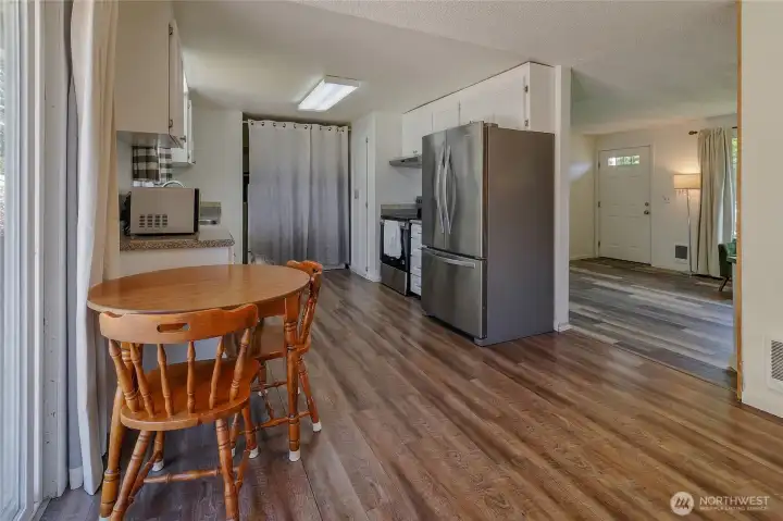 Kitchen view with eating area looking back to family room