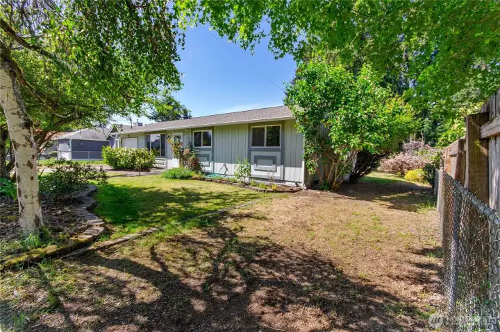 Side view of home showing access to back yard with boat trailer access through fully fenced access
