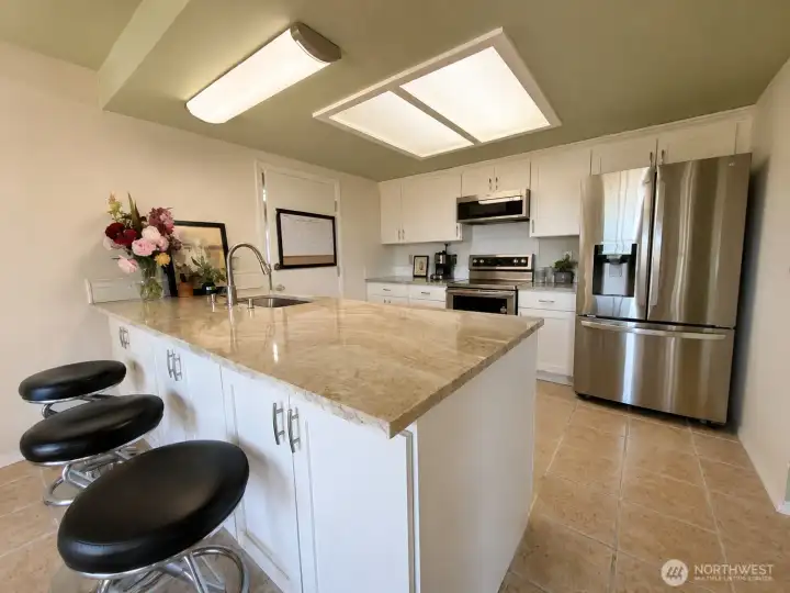 Welcome to your updated modern kitchen with stone counter tops, an eat in area & lots of cabinet space. Welcome to your updated modern kitchen with stone counter tops, an eat in area & lots of cabinet space.