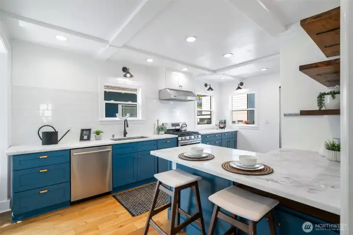 So many fun touches, like box beam ceilings, vintage inspired lighting fixtures and lots of windows letting in south and west facing light.