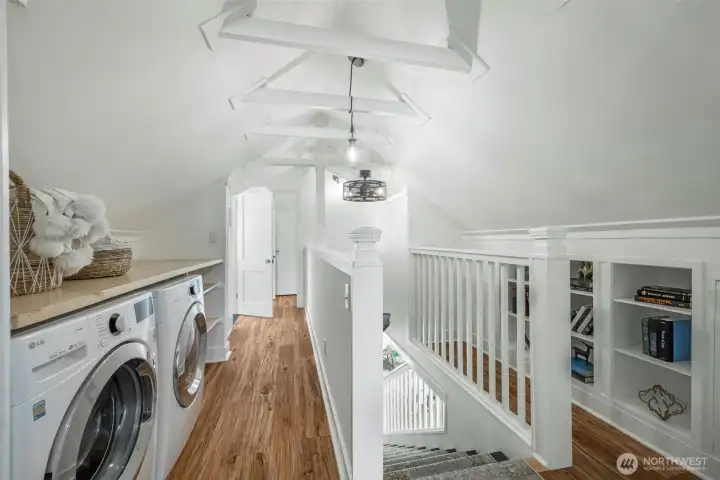 Going upstairs, it is such a cool space! The ceiling trusses are exposed and there are awesome built-ins and laundry where you keep your clothes!