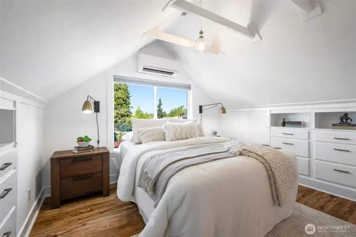 The primary bedroom lofted up in the sky with lovely views of the Olympic Mountain range. There is a mini-split in this room as well for A/C.