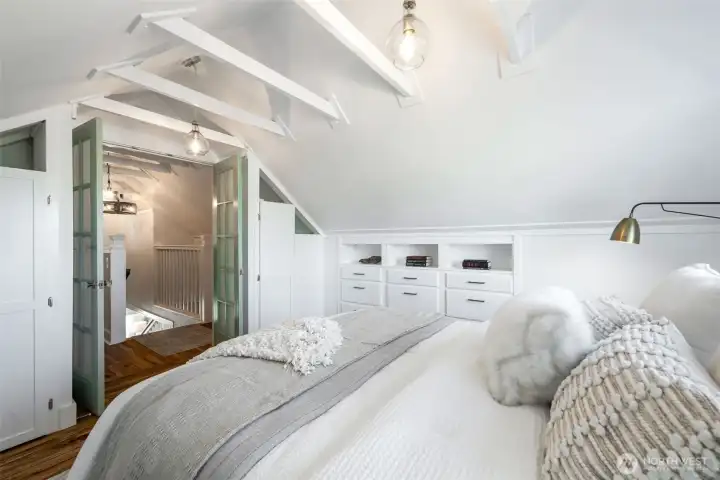 There are also hanging closets on both sides of the room and French doors that go out into the landing.