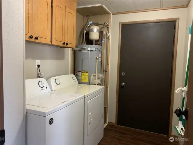 Utility room with extra storage space and access to the carport