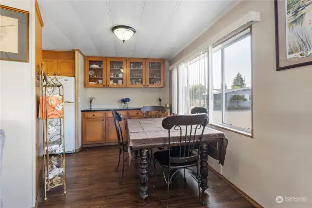 Dining room with built-in display cabinets, storage cabinets and easy access to the kitchen.