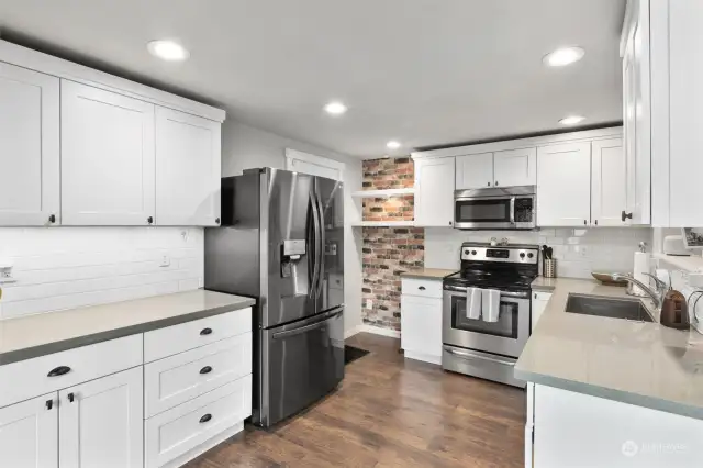 Your culinary haven has been illuminated with sophisticated undercabinet lighting, designed to enhance meal prepping and beautifully highlight your full-height backsplash. There's also gas plumbing for the stove!