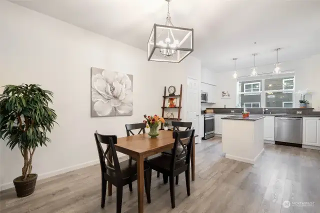 Great dining space with room for entertaining.  Nice hanging fixture complementing the Luxury Vinyl Plank flooring.