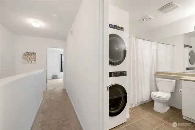 2nd floor bathroom has bath tub and nice stacked washer & dryer