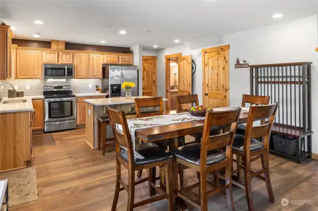 Remodeled kitchen with quartz counters, custom tile backsplash and undermount cabinet lighting.