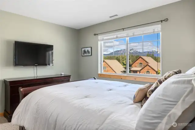 Imagine waking up to this. Spacious primary with tv and walk-in closet.