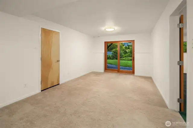 The downstairs flex room offers a quiet, versatile space with direct access to the backyard through a set of glass doors that bring in natural light and garden views. Whether used as a media room, home gym, guest suite, or creative studio, the layout provides privacy and flexibility to suit your needs. With soft carpeting and neutral finishes, it’s a blank canvas ready to adapt to your lifestyle. The adjacent room and full lower-level access make it an ideal extension of the home’s functional living space.