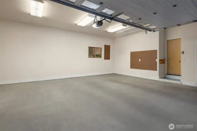 The oversized 21 x 25 foot garage offers ample space for two vehicles plus additional room for storage, tools, or a small workshop setup. With finished walls, built-in pegboards, and overhead lighting, it's clean, bright, and ready for projects or organization. The direct access into the home through the laundry/mudroom adds everyday convenience, while the extra depth and width make this garage as functional as it is spacious. There is also a pull-down, foldable ladder access to a huge storoage area in the attic above.