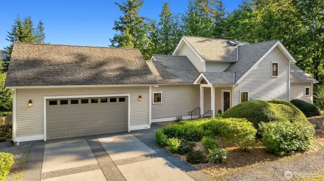From the street, 4714 Willis Street presents a clean, well-maintained exterior framed by mature landscaping and nestled into its forested setting. A gently sloped driveway leads to the oversized two-car garage, while a charming covered entryway welcomes you home. The architecture blends traditional lines with Northwest sensibility—simple, functional, and perfectly in tune with the natural surroundings. It’s a home that feels both tucked away and totally accessible, offering privacy without isolation.