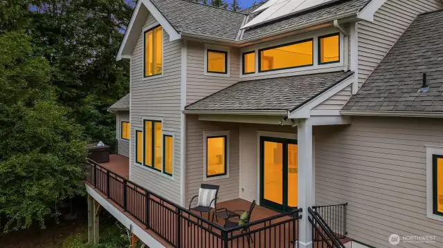 This elevated deck is a true extension of the living space—perfectly situated on the south side of the home to capture sun throughout the day and forest views in every direction. Whether you're relaxing with morning coffee, hosting friends, or unwinding in the built-in hot tub, the setting feels private, peaceful, and connected to nature. Notably, the south-facing siding has been upgraded to durable HardiPlank with a rainscreen installation detail—an added investment in both weather protection and long-term performance. It’s a space that blends comfort, function, and thoughtful construction.