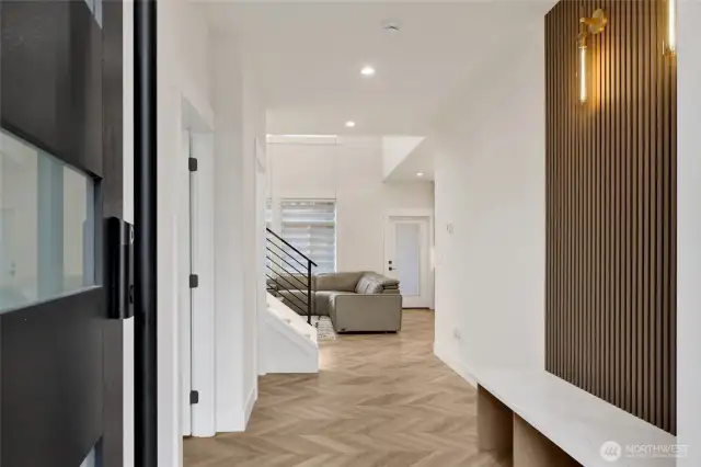 entry bench and Herringbone plank flooring throughout home