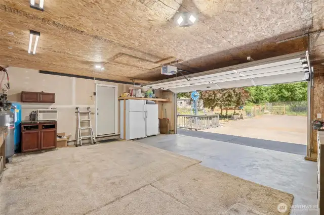 Spacious garage with built-in workbench and shelving—ideal for projects, hobbies, or extra storage. With direct outdoor access and plenty of lighting, it's a versatile space ready to support whatever you dream up.