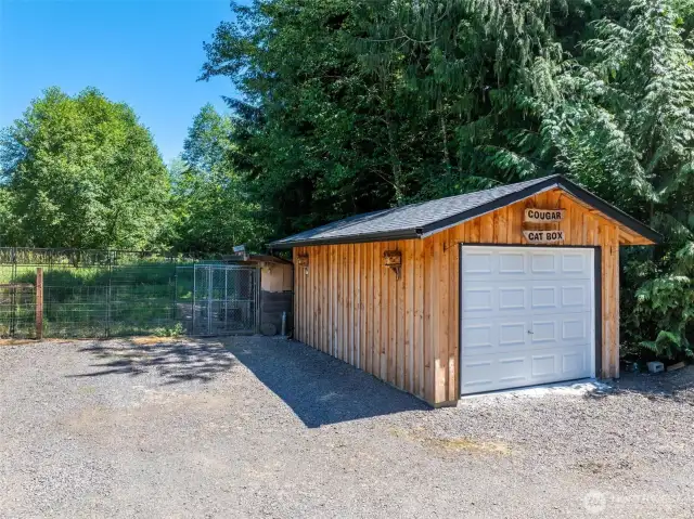 This versatile detached one-car garage offers additional storage or workspace, and just behind it, the fenced chicken coop is ready for your backyard flock.