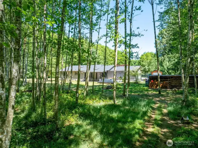 Surrounded by your own private forest, this property offers a peaceful retreat with trails, open space, and natural beauty just steps from your back deck. Whether you're dreaming of space to explore, relax, or garden, this acreage gives you room to breathe.