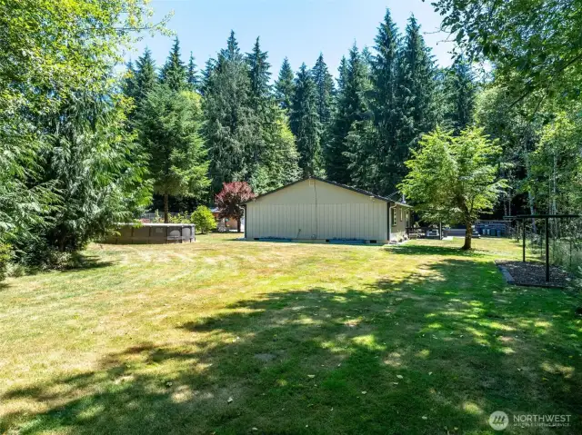 Expansive backyard with lush, open lawn surrounded by towering evergreens offers privacy and tranquility on nearly 8 acres across two parcels. Enjoy ample outdoor space for recreation, gardening, or future additions. A framed above-ground pool provides summer fun, while mature trees create a peaceful forested setting. Whether you're dreaming of homesteading, adding a shop, or simply relaxing in nature, this spacious yard supports it all. A rare opportunity to own a usable acreage retreat away from the noise of town and surrounded by the beauty of the Pacific Northwest.