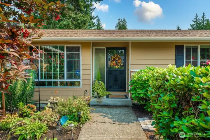Lush plantings on either side give a welcoming feel as you walk toward the front door!