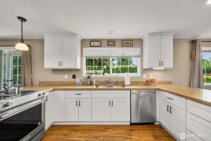 Such a great kitchen, lots of cabinets and counter space and wonderful view of the back yard.