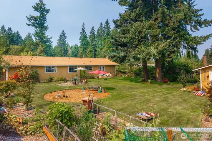 Plenty of back yard fun! Room for games, gardening and a big fire pit where you can relax and enjoy