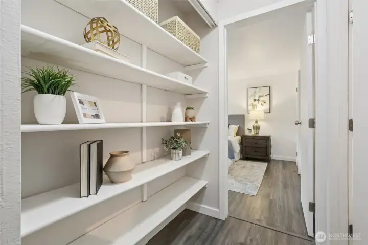 Cute built-in shelving lines the hallway leading to the primary bedroom.