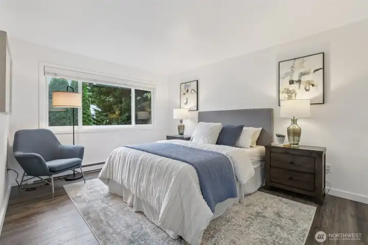 Picture windows fill the primary bedroom with great morning light as you get ready for busy days out on the town.