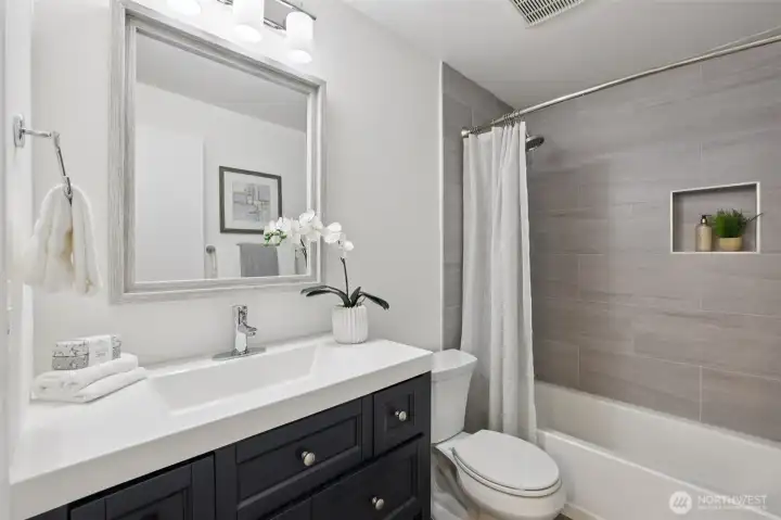 Stylishly updated full bath off of the hall, great for guests.