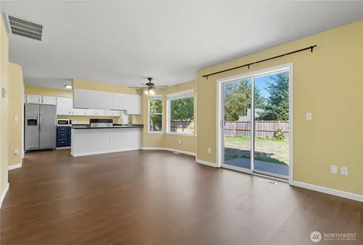 The double glass slider from the Great Room space takes you seamlessly into the huge fenced backyard.