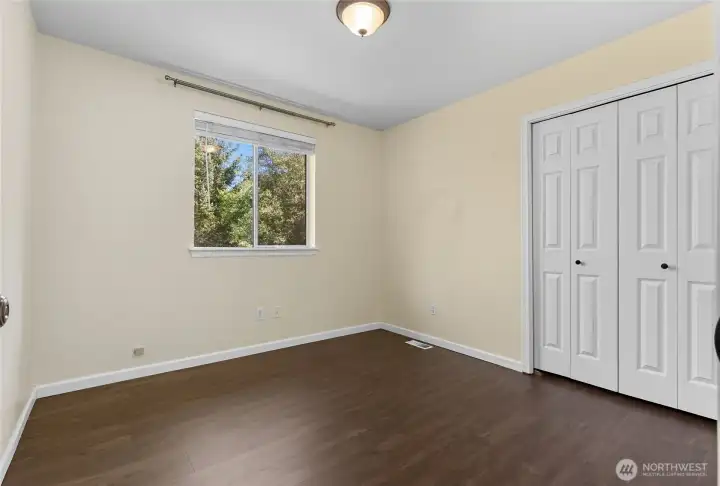 Upstairs bedroom looks out over the rear yard below.
