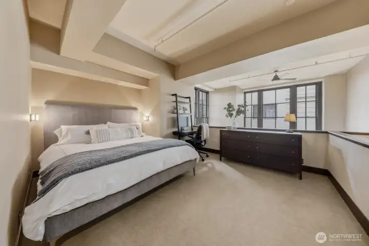 Spacious primary bedroom with 20' ceilings create a wonderful open atmosphere.