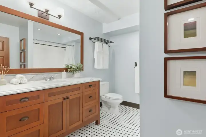 Beautifully tiled bathroom complete with a spacious vanity.