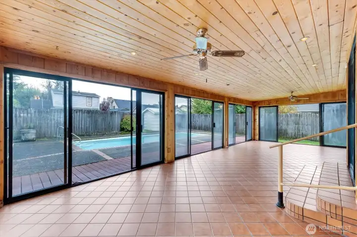 Sun room opens to the yard on three sides