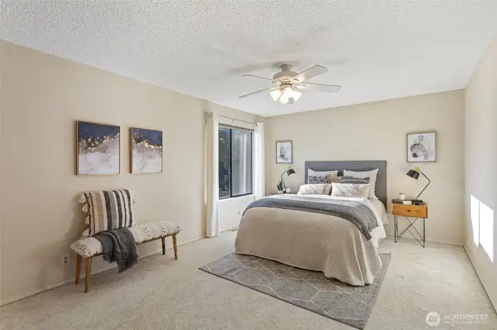 The generously proportioned primary bedroom suite offers space for a king-size bed, large furniture and designated seating areas.