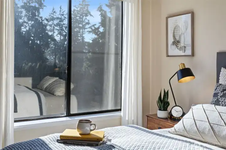 End-unit premium hallmarks of this home include the south wall primary bedroom window that overlooks conifers and grassy terrain. Opportunity abounds here to indulge in opening curtains, lingering and lounging while taking in the outside scenery!