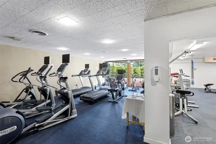 Elevate your fitness in a fully equipped gym designed for every workout style. From strength training to cardio, the facility also features a generous 'flex-mat' area—the perfect retreat for yoga, core work, or post-workout recovery.