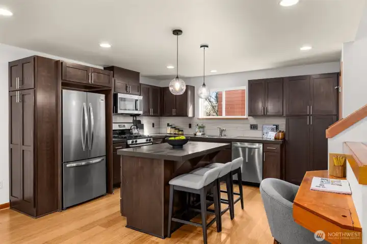 New stainless steel appliances, ample storage in the cherry wood cabinetry and a half bath on the same floor.
