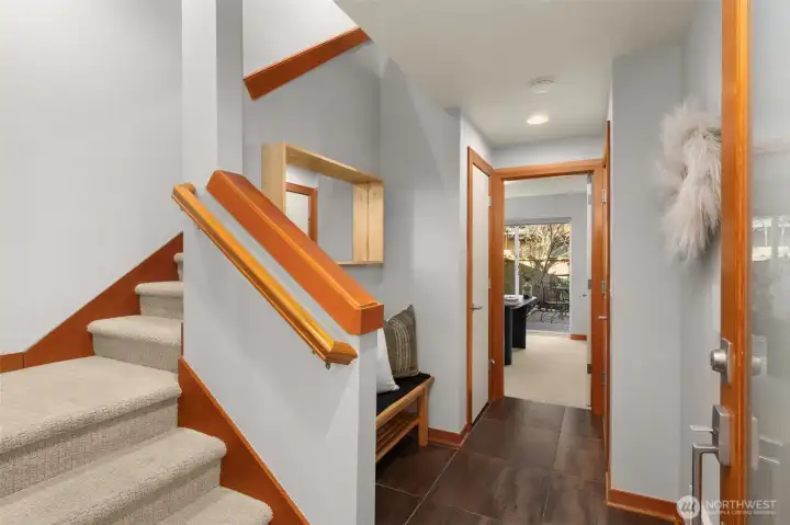 Entry on the main level features new carpet on the stairs, a full bedroom that leads to the backyard, coat closet and connects to your extra-deep private garage.