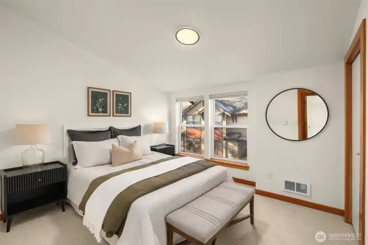 Primary bedroom on the upper level features fresh paint, new carpet and a full suite with a double sink vanity and a soaking tub/shower.