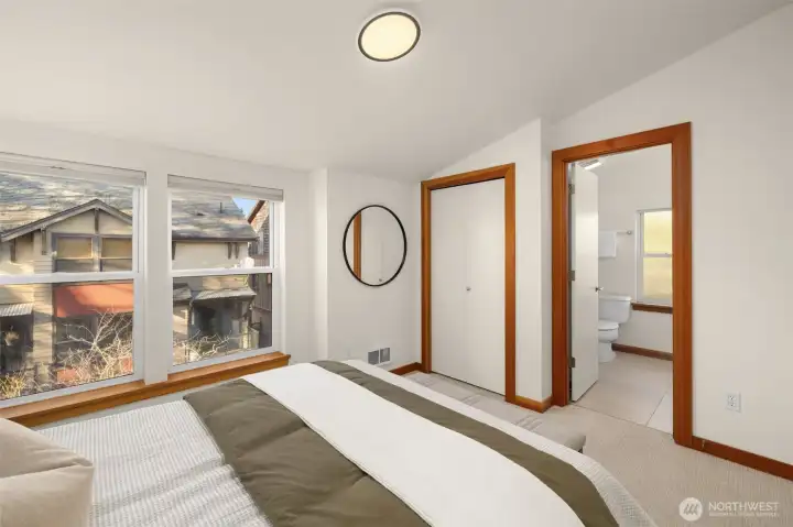 Primary bedroom features fresh paint, new carpet and a full suite with a double sink vanity and a soaking tub/shower.