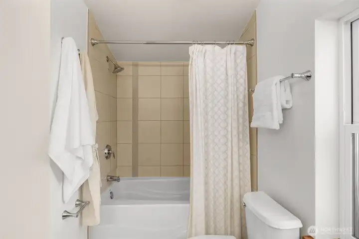 Tranquil ceramic tub/ shower off of the primary bedroom.
