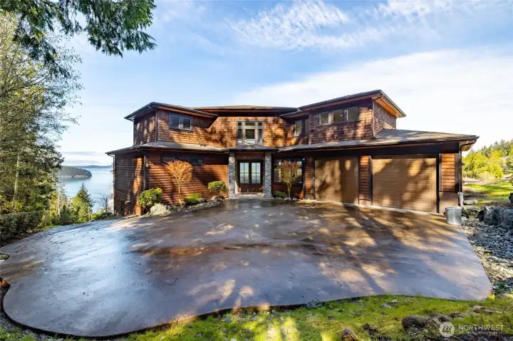 This paved entry courtyard is at the top of the driveway and provides extra parking.