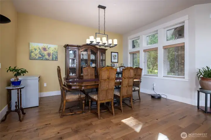 Formal dining area at "forest side" of home still has views across the living area.