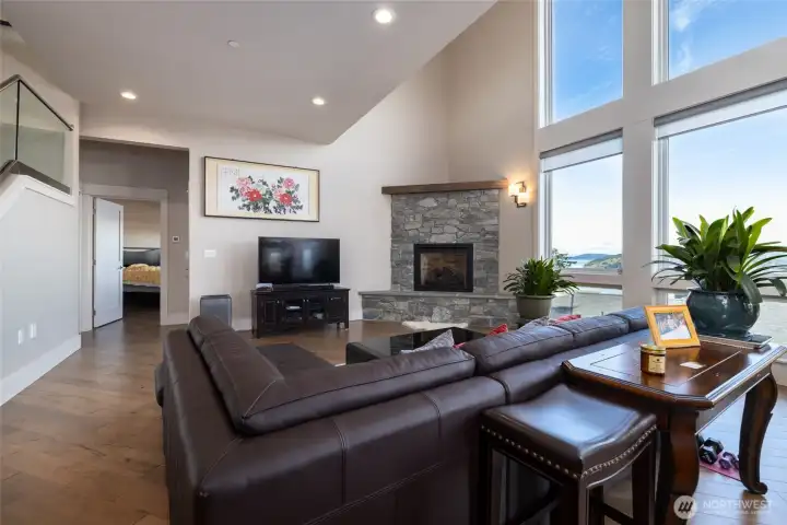 Main living area with view and hallway to half bath and on to the primary suite beyond.