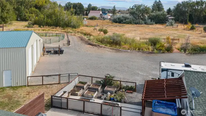 A look at the parking area with plenty of turning space for vehicles and also a look at the great raised bed garden area with wind protection!