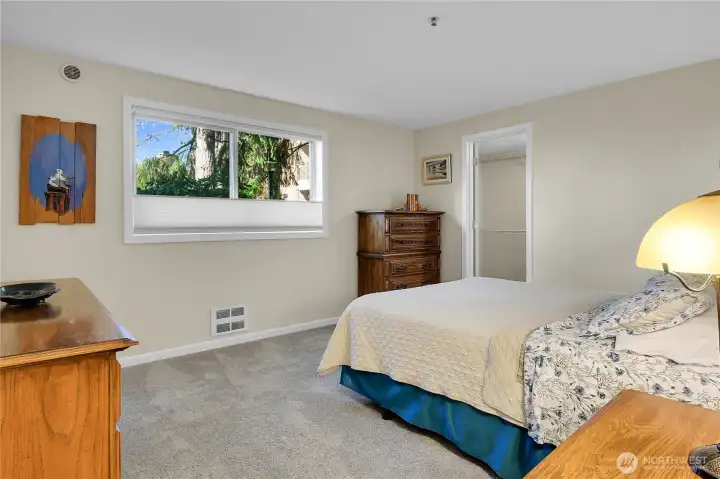 Primary bedroom; spacious walk-in closet enrty in background