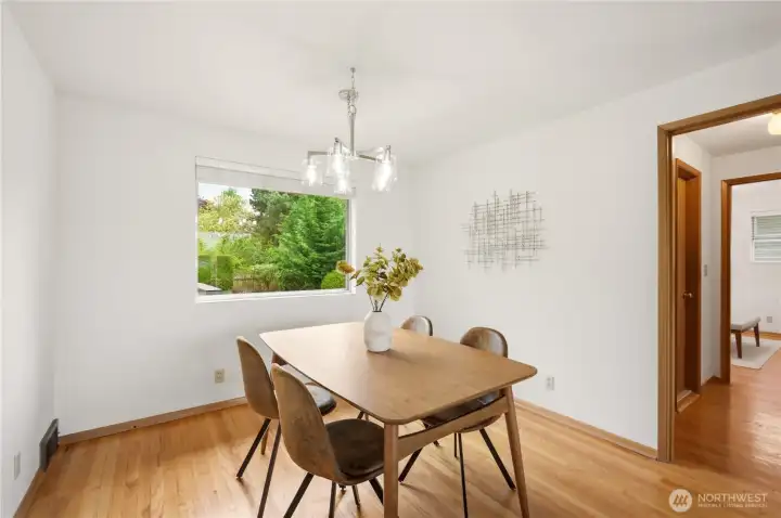 The dining room looks out over the lovely landscaped back yard and has a newly installed light fixture.